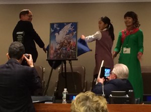 President Preston helps to unveil the winning peace poster.