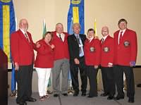 DGEs (L-R): Jerry Voss (SE), Judy Beaudry (NW), Chuck Edwards (SW), VDG Trainer PDG Leo Grossman, DGE Eunice Cameron (SKS), Garry Jopko (SKN), and Rick Swenson (NE).