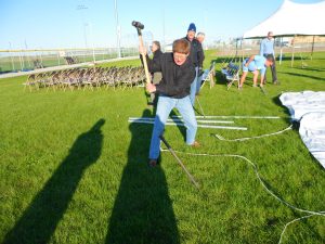 ID Robert takes a turn at driving in the spikes to support the tents.