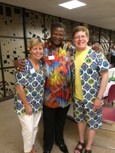 Lion Kathy and ID Robert wearing clothing made from fabric created by ID Alexis Gomes from Republic of the Congo who chaired the 2014-15 PR Committee.