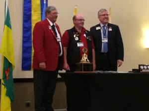 PCC Dennis (middle) receives the Leadership Medal from ID Larry Dicus representing International President Joe Preston. 