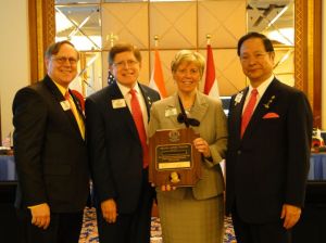 LCIF Chair Preston and LCI President Yamada present Lion Kathy with a Melvin Jones Fellowship.