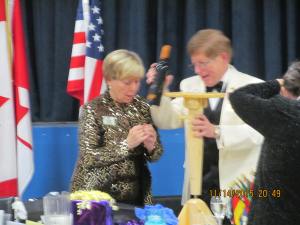 A portable table stand holds two glasses and a bottle of wine--handcrafted by PDG Joe.